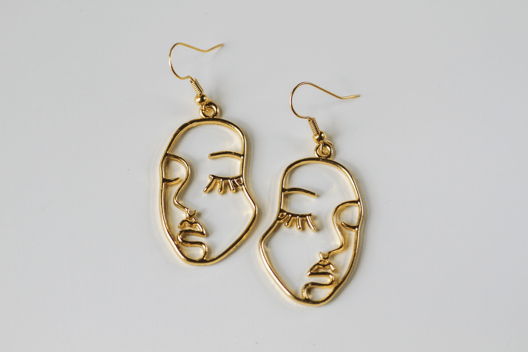 gold abstract face earrings